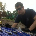 Travis Ziebro, CEO of PLO wearing shades and black shirt looking at tools