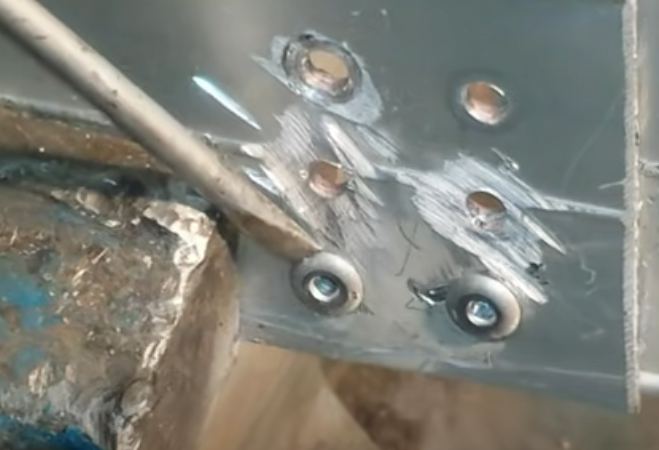 Removing the pop rivet with a hammer
